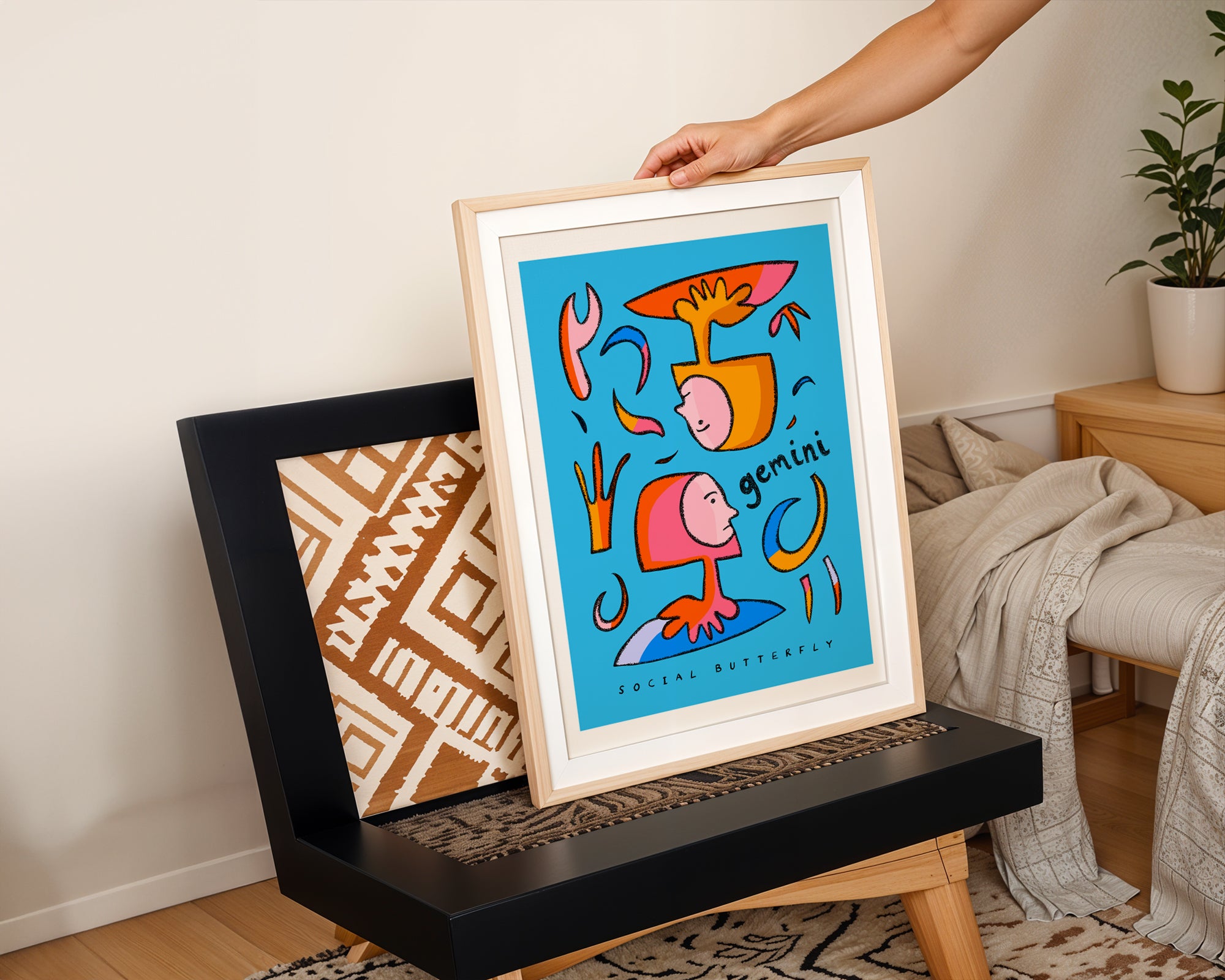 Gemini art print with the gemini trait social butterfly written underneath the hand-drawn illustration on a blue background.