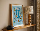 Libra zodiac art print with the libra trait balanced beauty written underneath the hand-drawn illustration on a blue background.