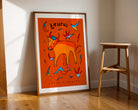 Taurus zodiac art print of a hand-drawn bull with the taurus trait loyal and boujee written underneath on an orange background.