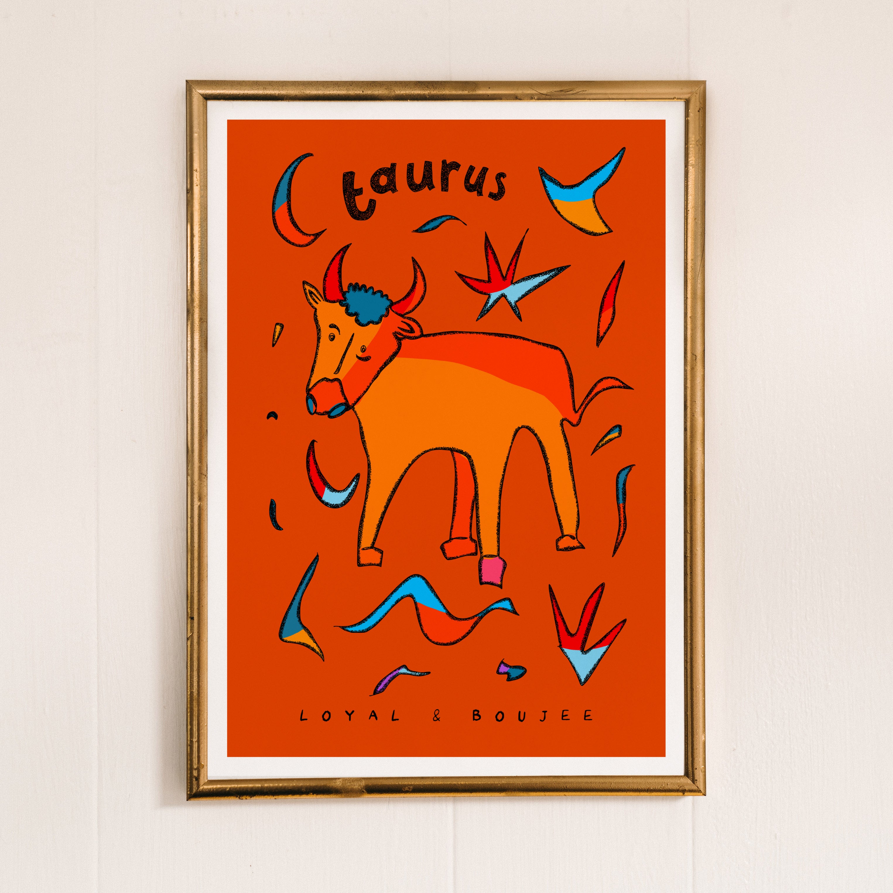 Taurus zodiac art print of a hand-drawn bull with the taurus trait loyal and boujee written underneath on an orange background.